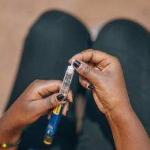 Woman in Rwanda preparing her diabetes medication